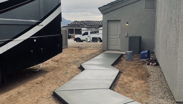 concrete side walk poured and finished around a home in Kingman, Arizona.